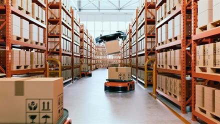 Automated warehouse aisle with racked inventory